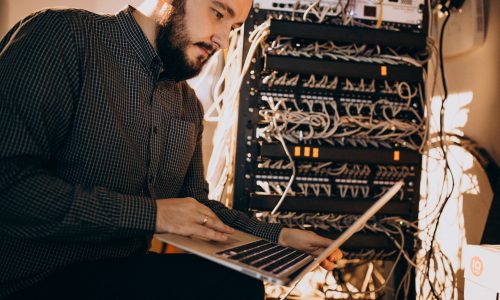 Young it service man repairing computer